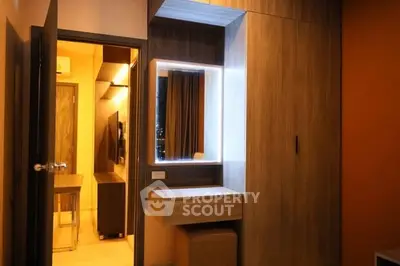 Modern bedroom with stylish wooden wardrobe and illuminated vanity mirror