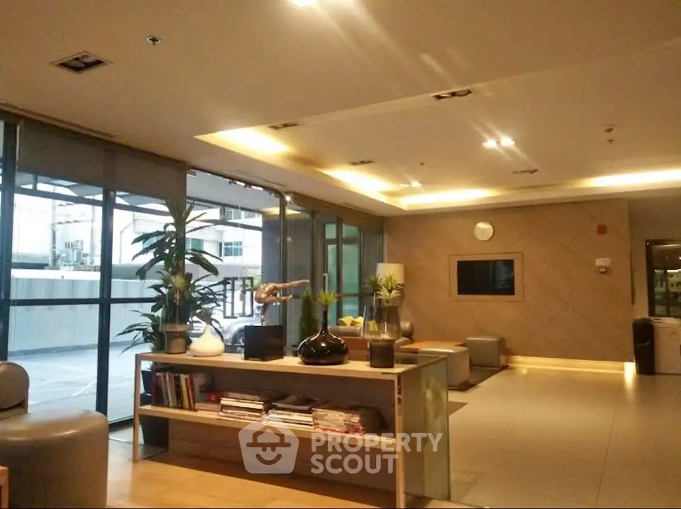 Modern lobby with stylish decor and ample natural light, featuring comfortable seating and contemporary design.