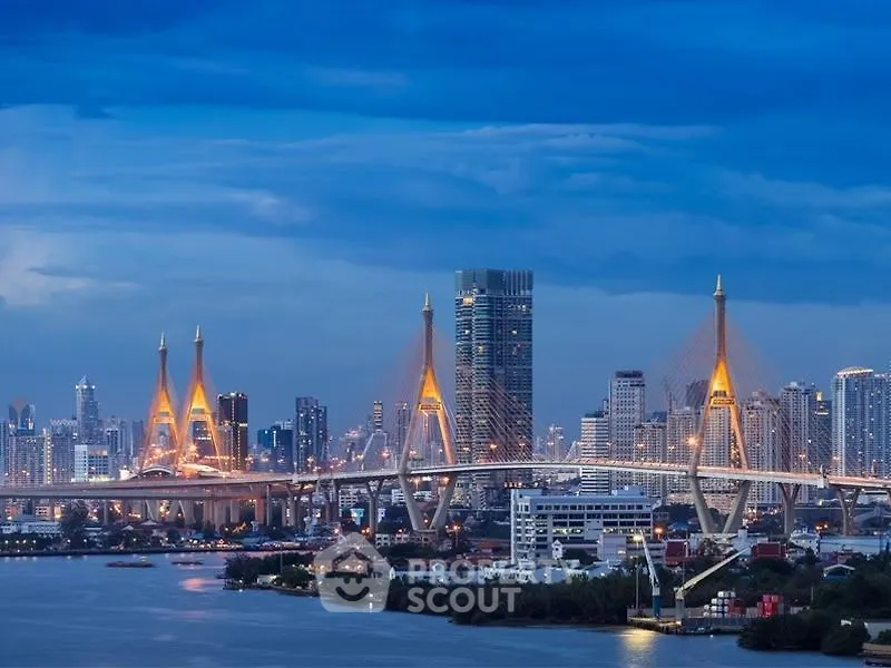 Stunning cityscape with illuminated bridge and skyline at dusk, showcasing urban architectural beauty.