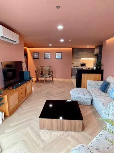 Spacious living room with modern decor and open kitchen layout