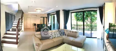 Spacious modern living room with large windows and stylish decor