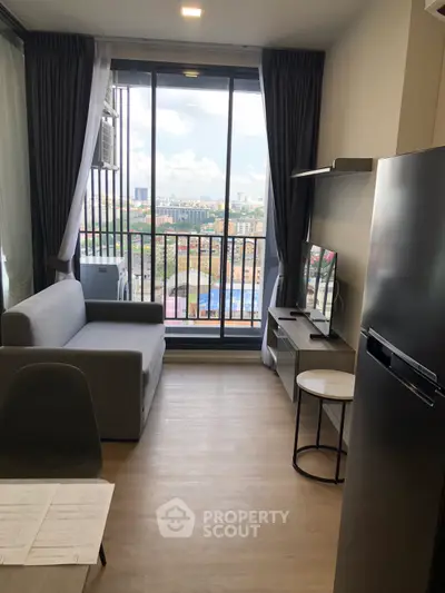 Modern living room with city view, featuring sleek furniture and large windows for natural light.