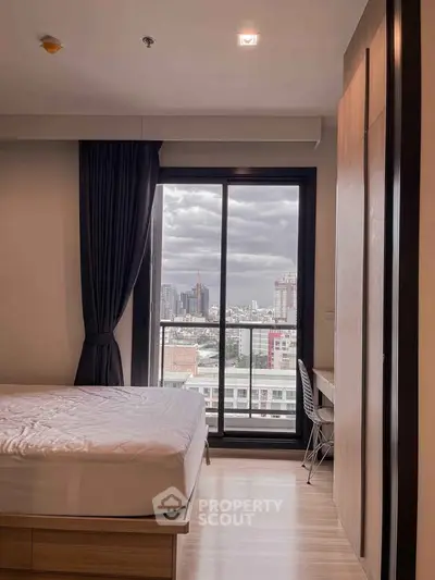 Modern bedroom with city view, featuring a cozy bed and sleek design, perfect for urban living.