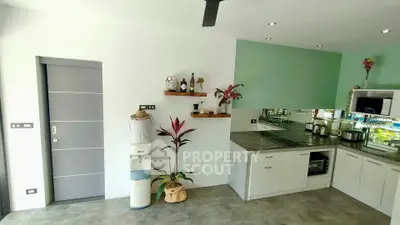 Modern kitchen with sleek design, featuring granite countertops, built-in appliances, and stylish decor.