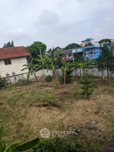 Spacious residential plot with lush greenery and potential for development in a serene neighborhood.