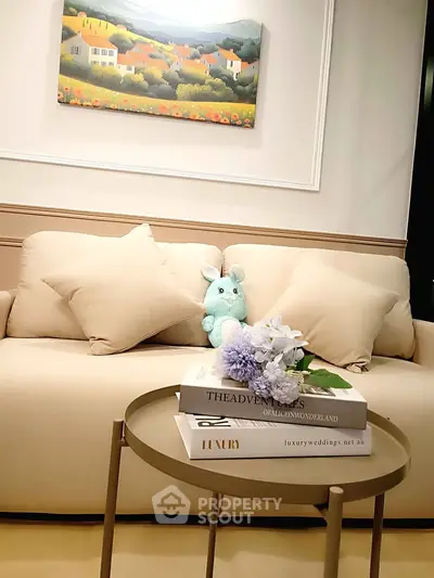 Elegant living room with plush sofa, chic decor, and stylish coffee table in modern apartment.