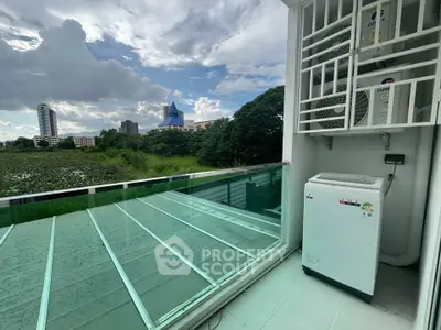 Spacious balcony with scenic view and modern washing machine setup