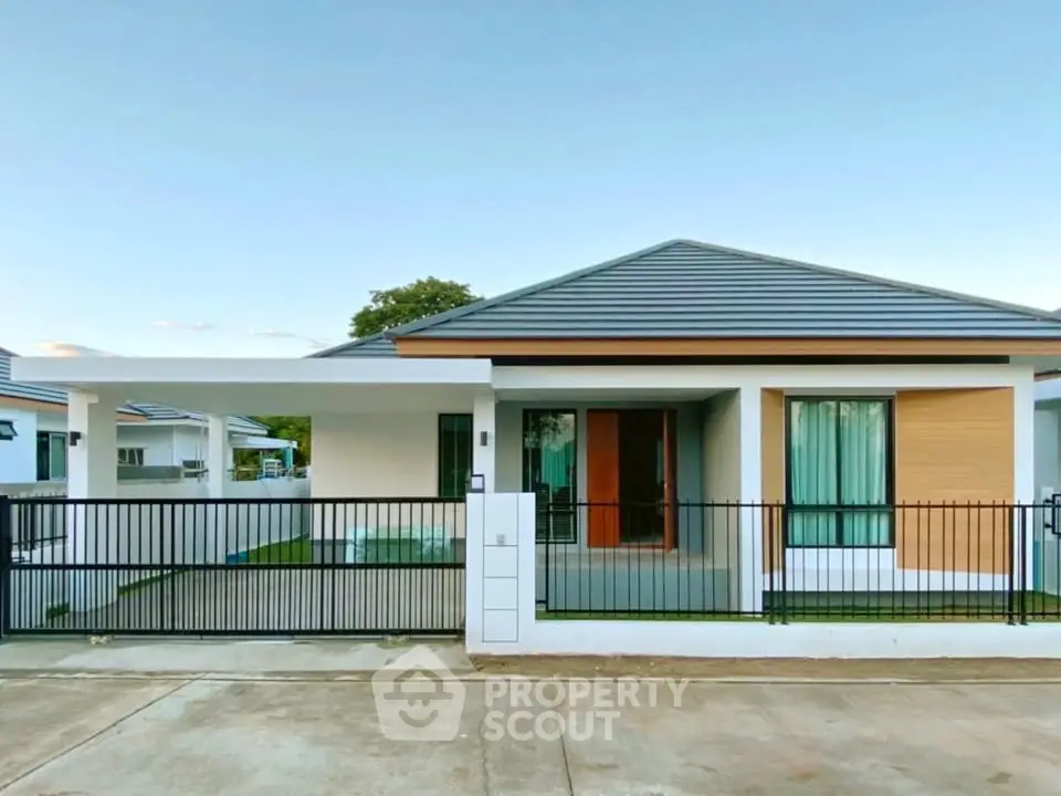 Modern single-story house with sleek design and spacious front yard