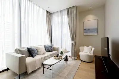 Elegant modern living room with floor-to-ceiling windows and stylish decor.