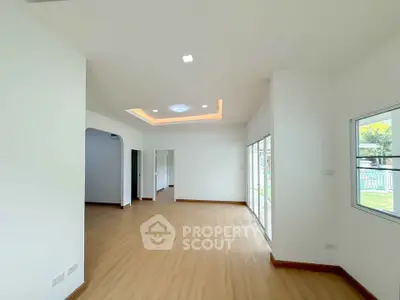Spacious modern living room with wooden flooring and large windows