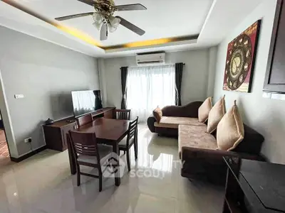 Spacious living room with modern furniture and natural light, perfect for relaxation and entertainment.