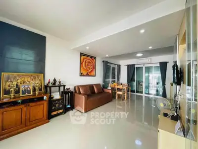 Spacious living room with modern decor and large windows for natural light.