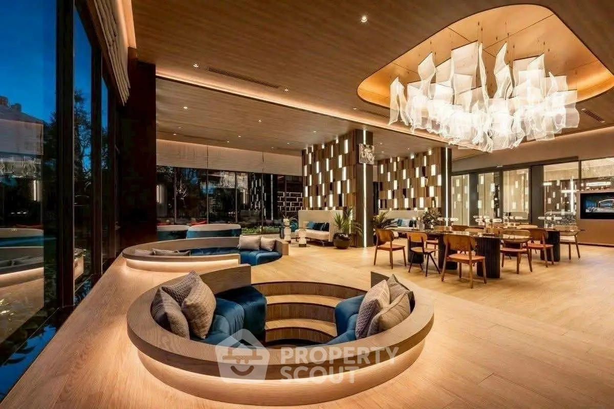 Luxurious modern living room with unique sunken seating and elegant chandelier, perfect for entertaining.