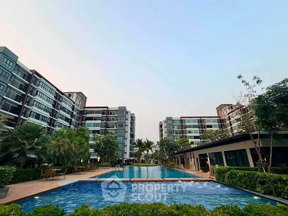 Luxurious residential complex with stunning pool and lush greenery