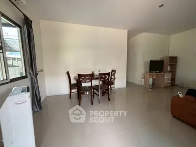 Spacious living room with dining area and modern furnishings in a bright, open layout.