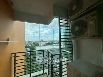 High-rise balcony with city view and air conditioning units