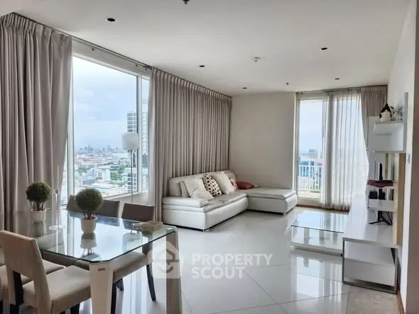 Spacious modern living room with panoramic city views and elegant furnishings.