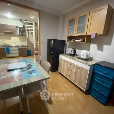 Cozy kitchen with modern appliances and dining area in stylish apartment.