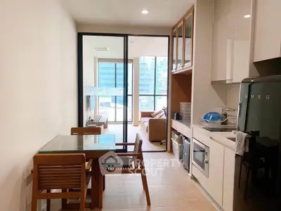 Modern kitchen and living area with sleek appliances and city view.
