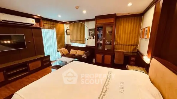 Luxurious bedroom with elegant wooden decor and cozy seating area