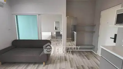 Modern apartment interior with sleek furniture and open layout, featuring a cozy living area and stylish decor.