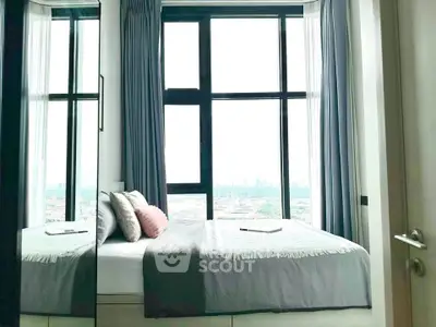 Modern bedroom with large windows offering stunning city views and elegant decor.