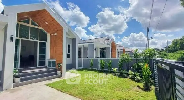 Charming modern house with lush garden and clear blue sky