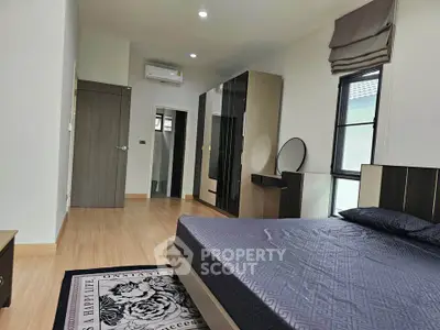 Spacious modern bedroom with stylish decor and natural light