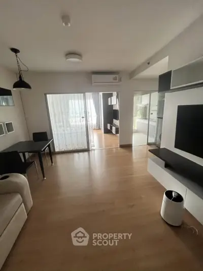 Spacious modern living room with sleek furniture and large windows for natural light.