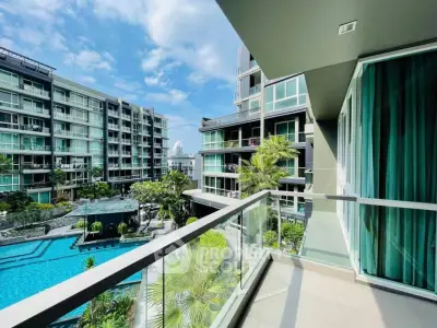 Stunning balcony view overlooking modern pool and luxury apartments