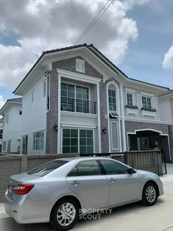 Stunning two-story house with elegant facade and spacious driveway, perfect for modern family living.