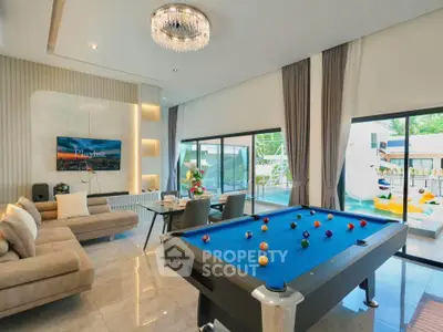 Luxurious living room with pool table and modern decor, perfect for entertainment.