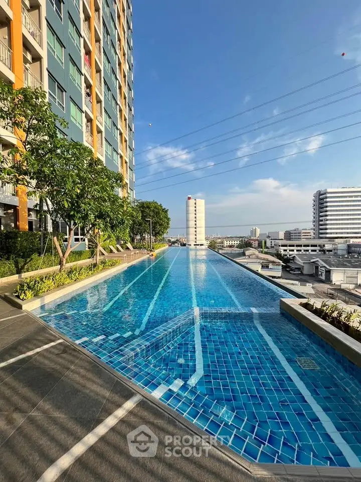 Luxurious high-rise building with stunning rooftop pool and city view.