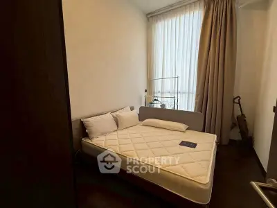 Cozy bedroom with natural light and modern decor in a stylish apartment.