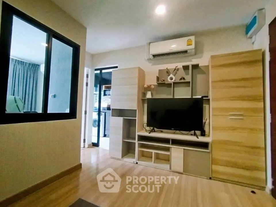 Modern living room with sleek wooden furniture and air conditioning unit