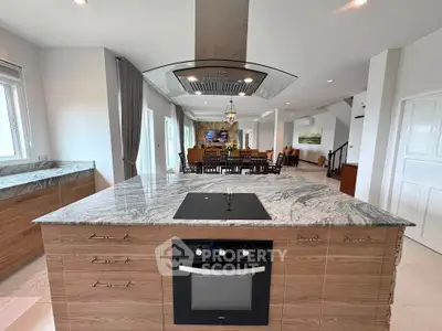 Spacious modern kitchen with marble island and open layout in luxury home