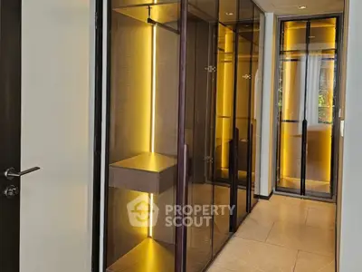 Luxurious hallway with modern glass closets and ambient lighting