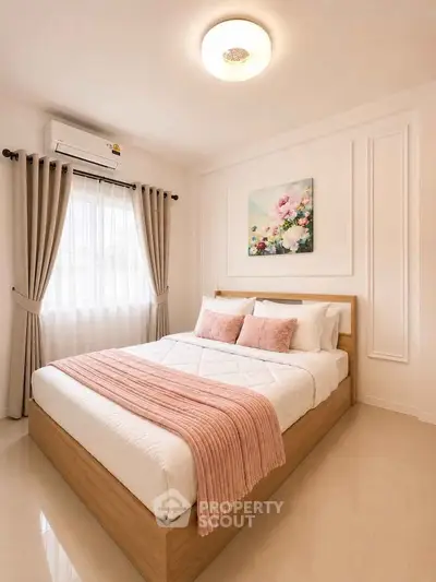Elegant bedroom with cozy decor and natural light, featuring a stylish bed and modern furnishings.