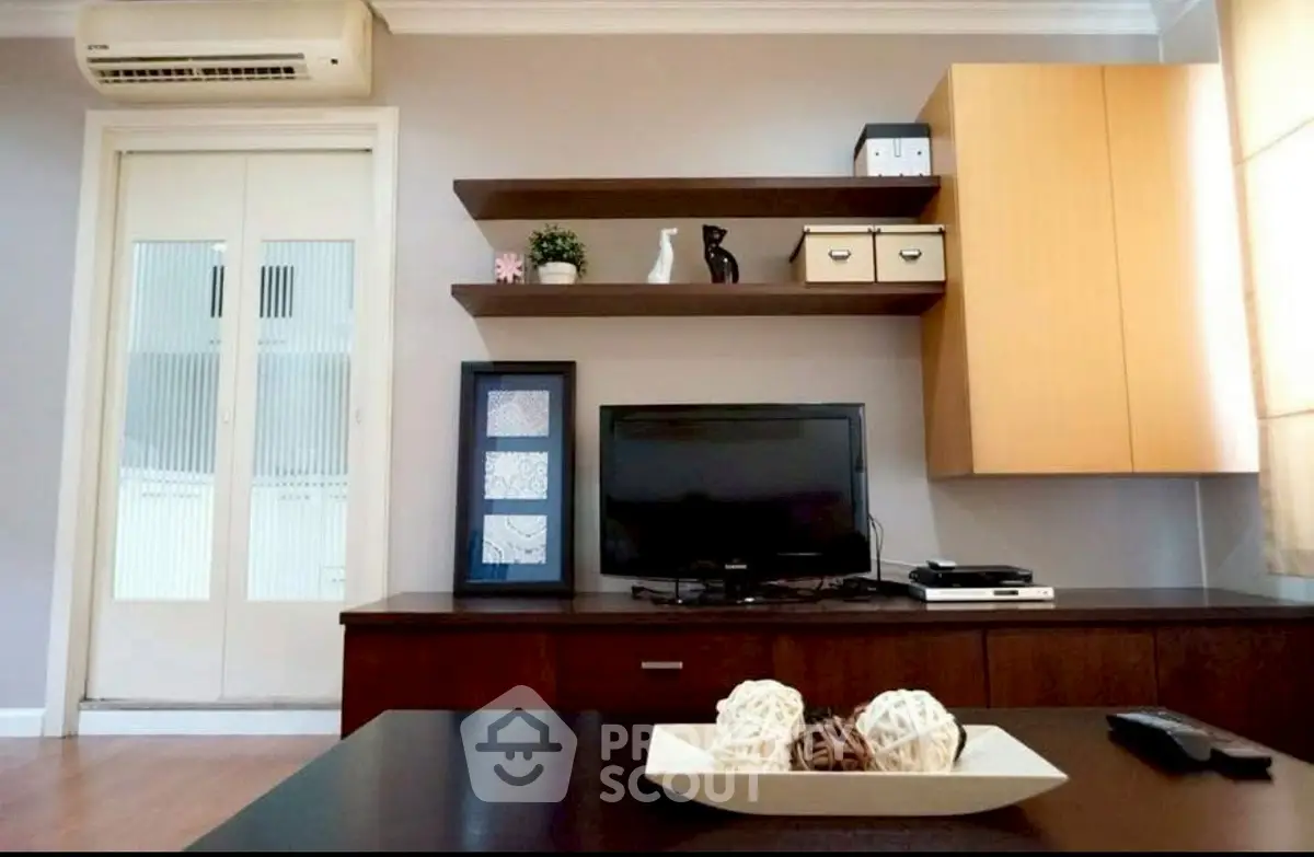 Modern living room with sleek TV setup and stylish shelving