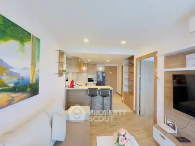 Modern open-plan living room with stylish kitchen and cozy seating area.