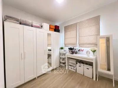 Spacious bedroom with modern wardrobe and vanity setup, perfect for organized living.
