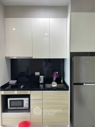 Modern compact kitchen with sleek cabinets and stainless steel appliances
