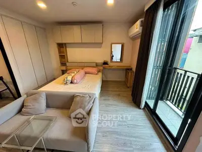 Modern bedroom with balcony access and stylish furnishings in urban apartment