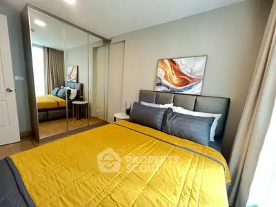 Modern bedroom with mirrored wardrobe and stylish decor in cozy apartment.
