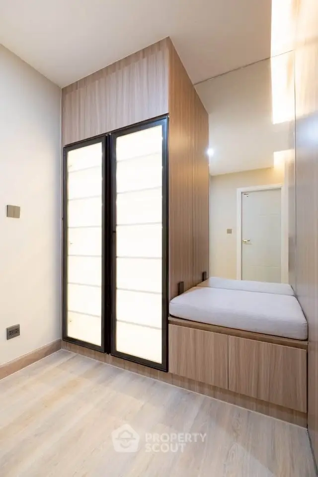 Modern minimalist hallway with built-in storage and seating area