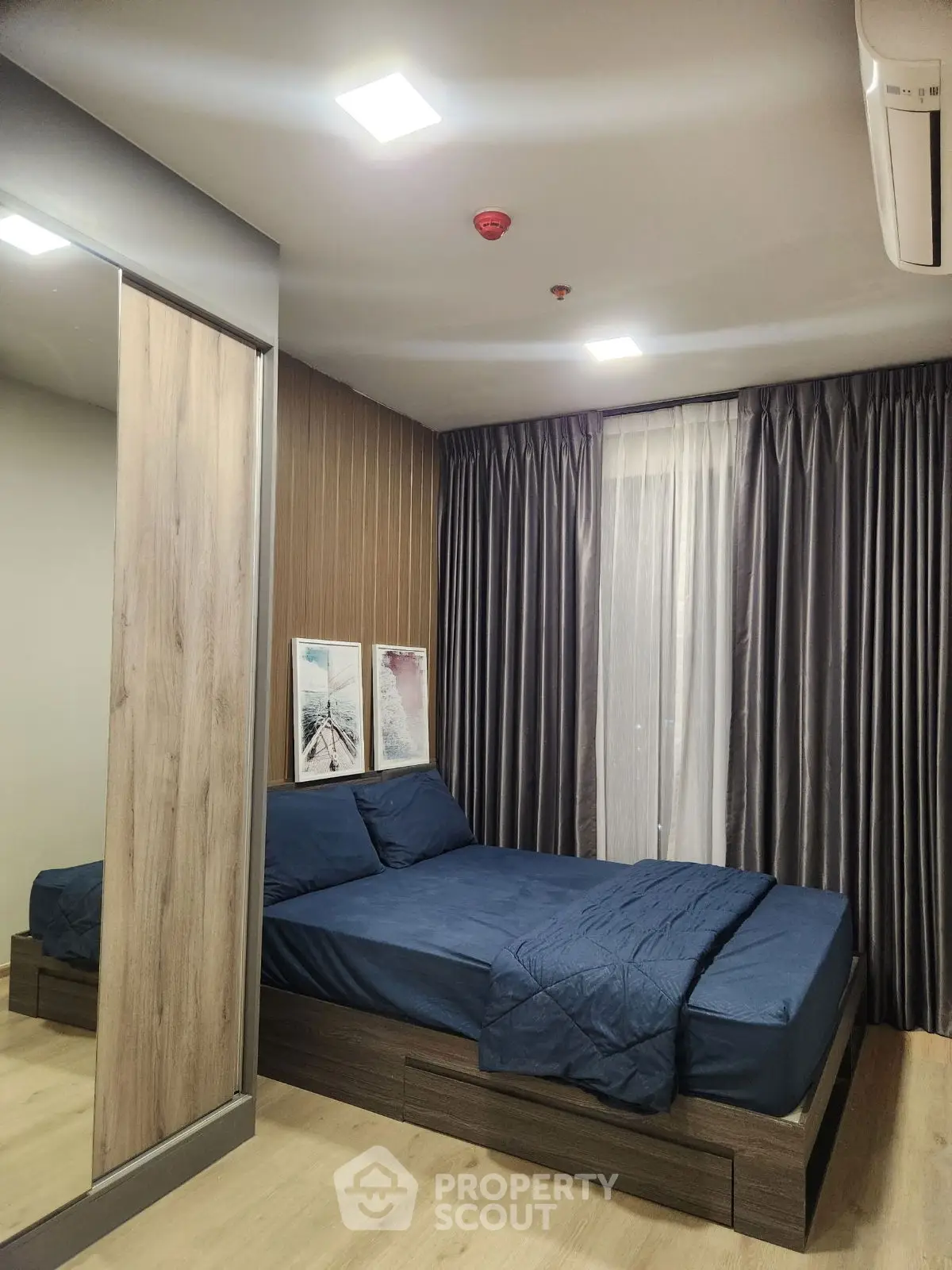 Modern bedroom with stylish decor and cozy ambiance, featuring a comfortable bed and elegant curtains.