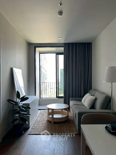 Modern living room with cozy sofa, stylish decor, and balcony view.