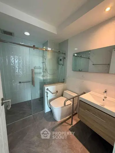 Modern bathroom with sleek fixtures and glass shower enclosure