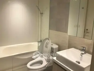 Modern bathroom with sleek fixtures, including a bathtub, toilet, and basin, showcasing a clean and minimalist design ideal for urban living.