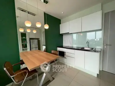 Modern kitchen with sleek design and stylish lighting in a contemporary apartment.